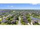 Expansive aerial view showcasing a neighborhood with well-manicured lawns, mature trees, and a serene pond at 10054 Win Star Way, Fishers, IN 46040