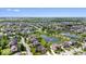 Wide aerial perspective of a residential area with lush landscaping, winding streets, and a central pond feature at 10054 Win Star Way, Fishers, IN 46040