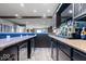 Finished basement featuring a stylish bar with seating, liquor and under counter refrigerators at 10054 Win Star Way, Fishers, IN 46040