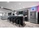 Finished basement featuring a stylish bar with seating, neon sign and stainless steel refrigerator at 10054 Win Star Way, Fishers, IN 46040