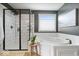 The bathroom has a sleek glass shower, a soaking tub, and a stool for added convenience at 10054 Win Star Way, Fishers, IN 46040