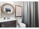 Bathroom featuring a modern vanity, toilet, mirror, and a guitar chords poster at 10054 Win Star Way, Fishers, IN 46040
