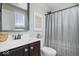 This charming bathroom offers a single vanity, a decorative mirror, and a shower with patterned curtain at 10054 Win Star Way, Fishers, IN 46040