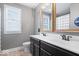 This bathroom features a double vanity, framed mirror, and a bright window for plenty of natural light at 10054 Win Star Way, Fishers, IN 46040