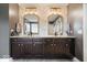This bathroom features a granite countertop, dark wood cabinetry and a unique wallpaper design at 10054 Win Star Way, Fishers, IN 46040