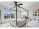 This bedroom features a four-poster bed, a ceiling fan and lots of natural light at 10054 Win Star Way, Fishers, IN 46040