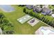 Aerial view of community amenities including a pool, playground, basketball court, and pond surrounded by well-maintained lawns at 10054 Win Star Way, Fishers, IN 46040