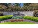 Stone entrance sign for Brooks Park, set among manicured greenery and colorful flowerbeds, creating a welcoming feel at 10054 Win Star Way, Fishers, IN 46040