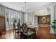 Formal dining room with hardwood floors, elegant lighting, and large windows providing natural light at 10054 Win Star Way, Fishers, IN 46040