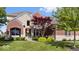 Charming two-story home features a combination brick and stone facade, professional landscaping, and a welcoming entryway at 10054 Win Star Way, Fishers, IN 46040