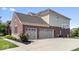 Spacious three-car garage with brick exterior and ample driveway parking at 10054 Win Star Way, Fishers, IN 46040
