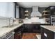 Modern kitchen with dark cabinets, granite countertops, stainless steel appliances, and open shelving at 10054 Win Star Way, Fishers, IN 46040