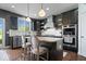 Modern kitchen featuring a center island with bar seating, stainless steel appliances, and sleek finishes at 10054 Win Star Way, Fishers, IN 46040