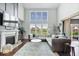 Spacious living room with fireplace, high ceilings, large windows, and comfortable seating at 10054 Win Star Way, Fishers, IN 46040