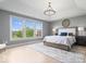 Tranquil main bedroom with tray ceilings, large windows, and a serene atmosphere at 10054 Win Star Way, Fishers, IN 46040