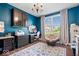 Inviting home office featuring vibrant blue walls, comfortable seating, and ample storage space at 10054 Win Star Way, Fishers, IN 46040