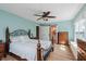 Bedroom features hardwood floors, ceiling fan, and a Primary bathroom with sliding barn door at 102 Roxbury Ln, Noblesville, IN 46062
