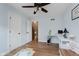 The secondary bedroom features wood flooring, white trim, and a door leading to the attic at 102 Roxbury Ln, Noblesville, IN 46062