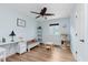 Bright and airy secondary bedroom with wood flooring, ceiling fan, and a large window at 102 Roxbury Ln, Noblesville, IN 46062