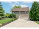 Charming home features a 3 car garage, manicured lawn, and lush landscaping, enhancing curb appeal at 102 Roxbury Ln, Noblesville, IN 46062