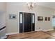 Inviting foyer with wood-look floors and decorative front door with sidelights at 102 Roxbury Ln, Noblesville, IN 46062