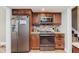 Modern kitchen with stainless steel appliances and custom wood cabinetry at 102 Roxbury Ln, Noblesville, IN 46062