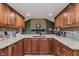Spacious kitchen with granite counters and a view to the stone fireplace at 102 Roxbury Ln, Noblesville, IN 46062