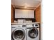 Well organized laundry area with front loading machines, countertop, and built-in cabinets for storage at 102 Roxbury Ln, Noblesville, IN 46062