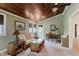 Cozy living room with wicker furniture, wood ceiling, and natural light at 102 Roxbury Ln, Noblesville, IN 46062