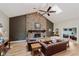 Bright living room featuring a stone fireplace, skylight, and ample seating at 102 Roxbury Ln, Noblesville, IN 46062