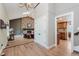 Open-concept living room with stone fireplace, skylight, and hardwood floors at 102 Roxbury Ln, Noblesville, IN 46062