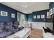 Stylish living room with blue walls, white trim, and wood floors, offering a cozy seating area at 102 Roxbury Ln, Noblesville, IN 46062