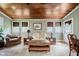 Bright sitting room with wood ceiling, natural light, and comfortable seating at 102 Roxbury Ln, Noblesville, IN 46062