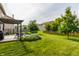 A well-manicured backyard features a pergola-covered deck and mature landscaping at 10273 Haag Rd, Brownsburg, IN 46112