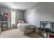 A cute bedroom features a twin bed, shelf and play kitchen set for hours of fun at 10273 Haag Rd, Brownsburg, IN 46112