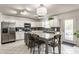 Bright kitchen boasts a large island with bar seating and modern appliances at 10273 Haag Rd, Brownsburg, IN 46112