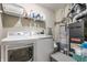 The laundry room includes a washer and dryer, storage shelves, and utility sink at 10273 Haag Rd, Brownsburg, IN 46112