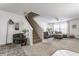 Spacious living room with neutral walls, carpeted stairs, and cozy seating at 10273 Haag Rd, Brownsburg, IN 46112