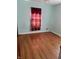Cozy bedroom with hardwood floors and light teal walls at 1030 N Concord N St, Indianapolis, IN 46222