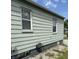 Side view of a house showing the green siding and windows at 1030 N Concord N St, Indianapolis, IN 46222