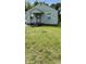 A single-story house with a compact front yard needing some TLC at 1030 N Concord N St, Indianapolis, IN 46222