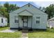 Quaint single-story home with a covered porch and a small front yard needing some TLC at 1030 N Concord N St, Indianapolis, IN 46222