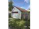 Exterior view of the garage with a wooden fence at 1030 N Concord N St, Indianapolis, IN 46222