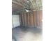 Interior of the detached garage, showing overhead door mechanism and unfinished walls at 1030 N Concord N St, Indianapolis, IN 46222