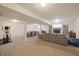 Spacious finished basement with exercise equipment, entertainment area, and built-in bookshelves at 10760 Independence Way, Carmel, IN 46032