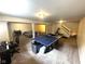 Basement rec room with ping pong table, sitting area, and workout area at 10760 Independence Way, Carmel, IN 46032