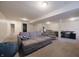 Finished basement featuring neutral carpet, a large sectional, and ample space for entertaining at 10760 Independence Way, Carmel, IN 46032