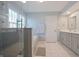 Modern bathroom with glass-enclosed shower, soaking tub, and stylish vanity with marble countertop at 10760 Independence Way, Carmel, IN 46032