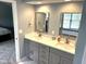 This bathroom features a double vanity with quartz countertops and modern fixtures at 10760 Independence Way, Carmel, IN 46032