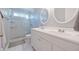 Bright bathroom features a double sink vanity, sleek glass shower, and tiled floor at 10760 Independence Way, Carmel, IN 46032